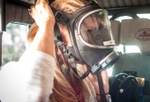 Kari Hagar tries on "the mask" during a ride on the Fontana fire truck to the parade